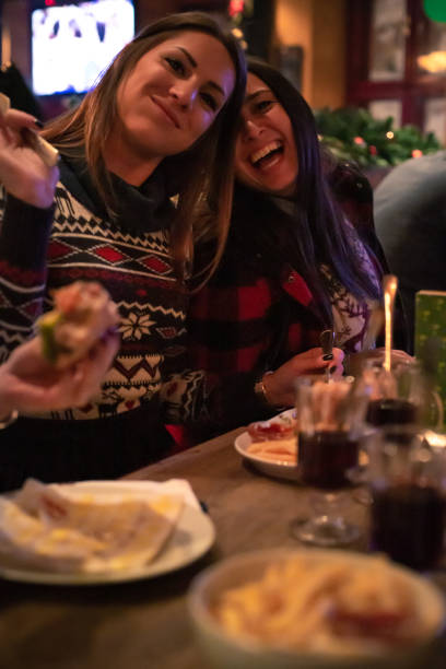 istock Cheerful girlfriends enjoying their outing at the bar 1290501248