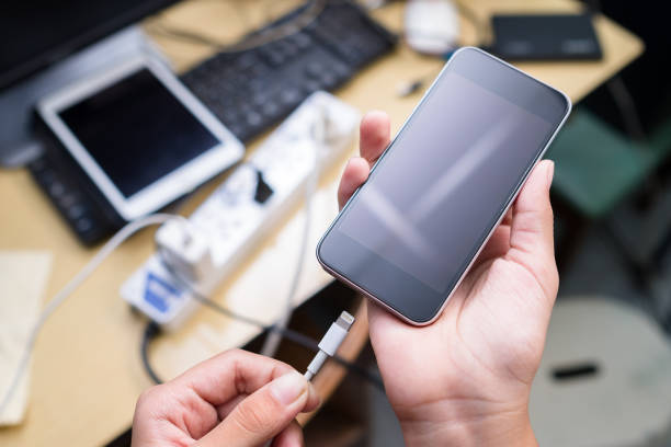 istock Charging Phone on Confused Desk 1290502514