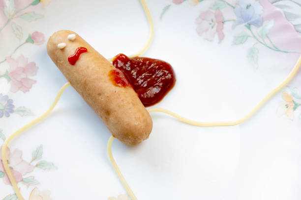 creative food. killed sausage with ketchup close up