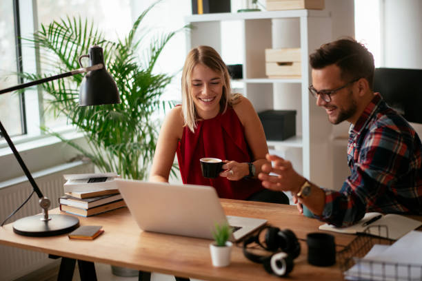 istock Businesspeople with laptop discussing new projects in office. 1290505425