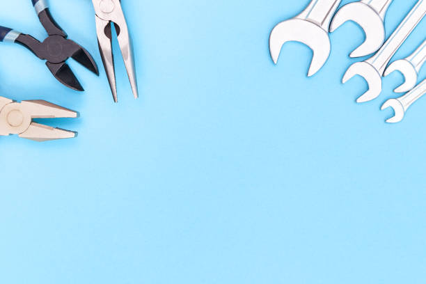 istock Tools worker, different pliers and many wrenchs on blue background, top view with free space 1290505617