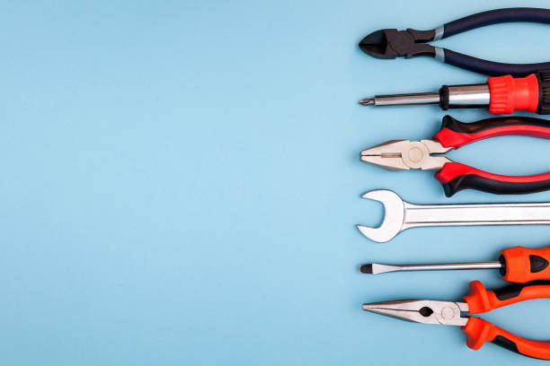 istock Various tools worker, hammer, wrench, screwdriver, pliers on blue background, top view with free space 1290505623