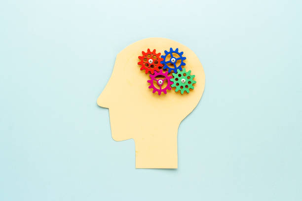 istock Brain model of gears and cogs on the paper head, top view 1290505701