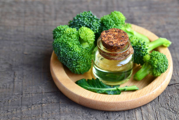 Broccoli seed essential oil in a glass bottle for skin care, naturopathy and wellness. stock photo