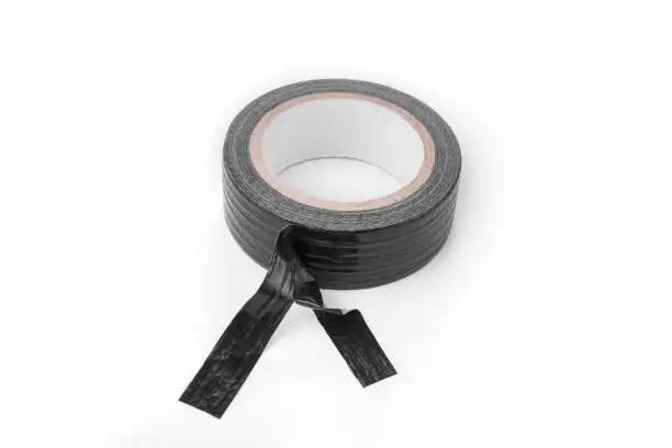 Roll of the Black duct tape for repair on a white