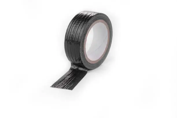 Roll of the Black duct tape for repair on a white