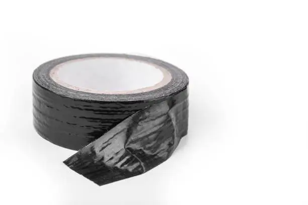 Roll of the Black duct tape for repair on a white