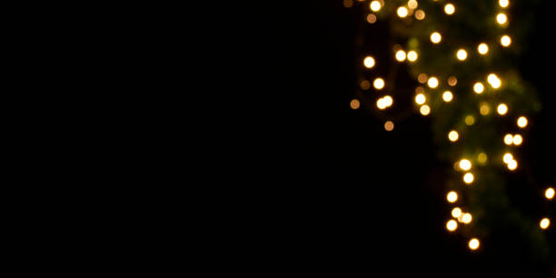 istock Gold lights on black background, bokeh effect 1290506444