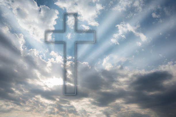 istock Christian cross in the sky with clouds 1290507406