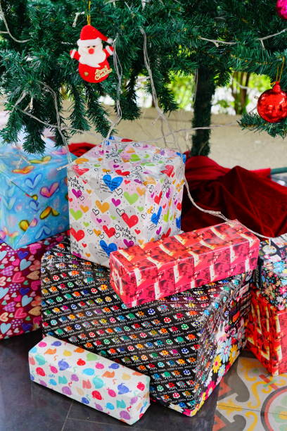 istock Santa on tree and Gift Box of Christmas presents under a Christmas tree 1290507694