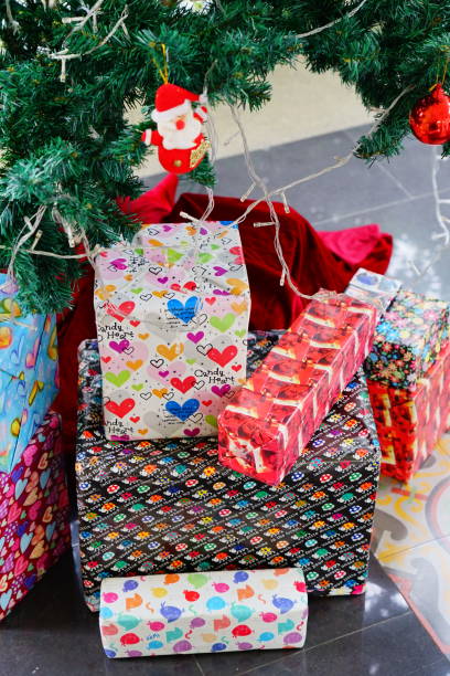 istock Santa on tree and Gift Box of Christmas presents under a Christmas tree 1290507746