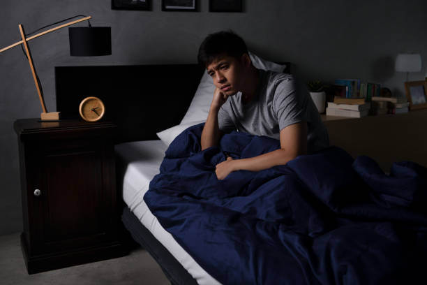 istock A depressed young man suffering from insomnia sitting in bed 1290508234