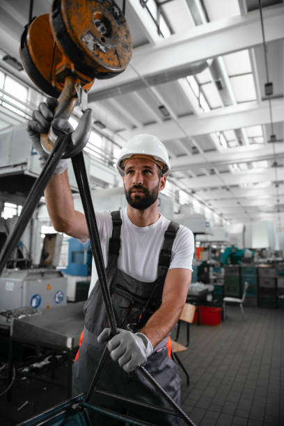 istock Young man with helmet working in the factory. 1290510137