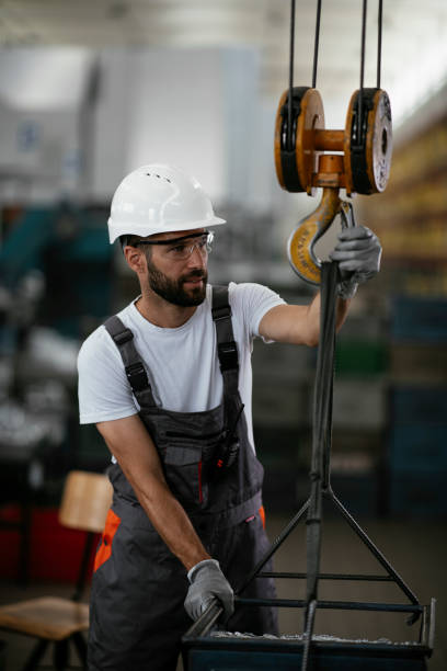 istock Young man with helmet working in the factory. 1290510517