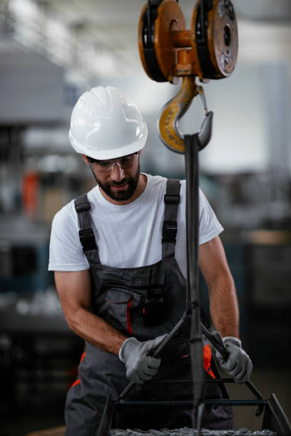 istock Young man with helmet working in the factory. 1290511535