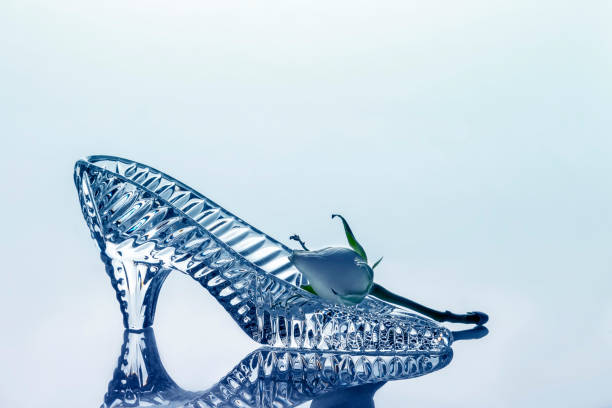 istock Crystal shoe and rosebud on a color gradient background. 1290514731