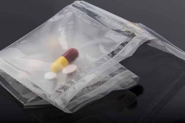 istock pills in a plastic bag on a black background. 1290528167