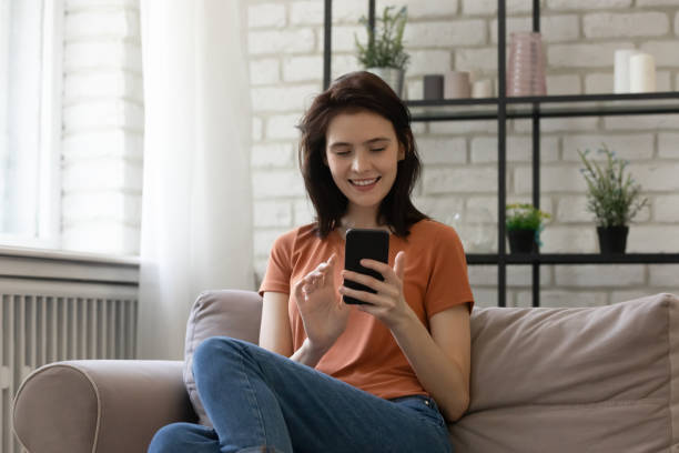 istock Relaxed millennial smiling woman using mobile phone applications. 1290529030