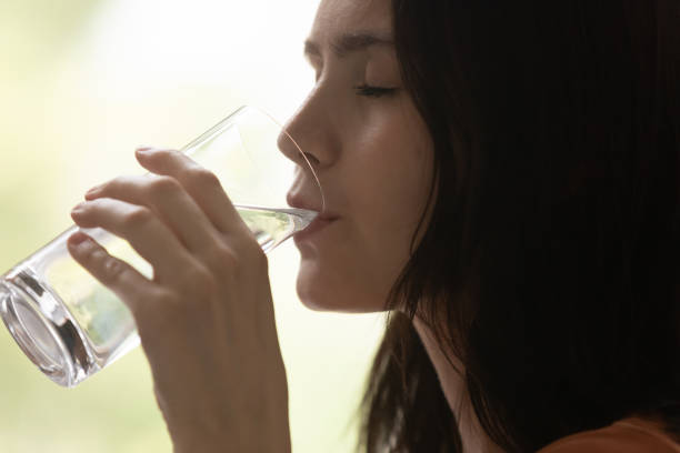 istock Millennial woman drinking mineral water, feeling thirsty. 1290529064