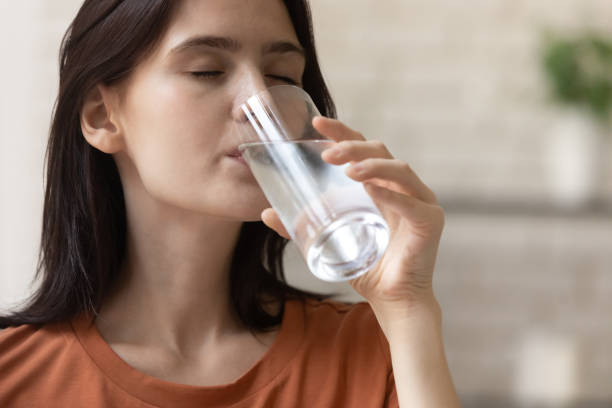 istock Happy young woman drinking fresh cool filtered water. 1290529069