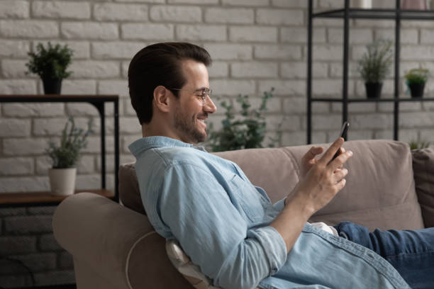 istock Addicted to technology happy young man using smartphone. 1290529095