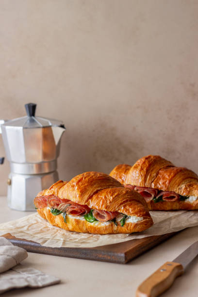 croissants sandwiches with prosciutto, basil and white cheese. french cuisine. breakfast. - morning tomato lettuce vegetable imagens e fotografias de stock