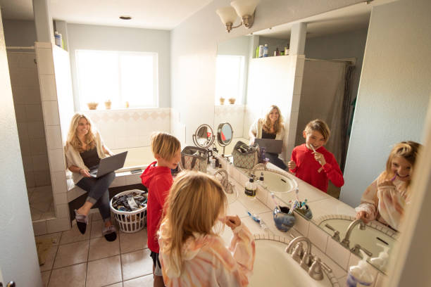 istock Single mother works from home while her kids play and distract her during Covid-19 lockdown 1290531440