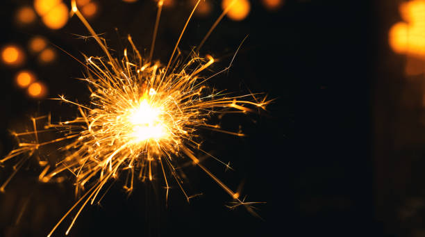 istock Sparklers Background,New year Sparklers and orange bokeh background 1290532301