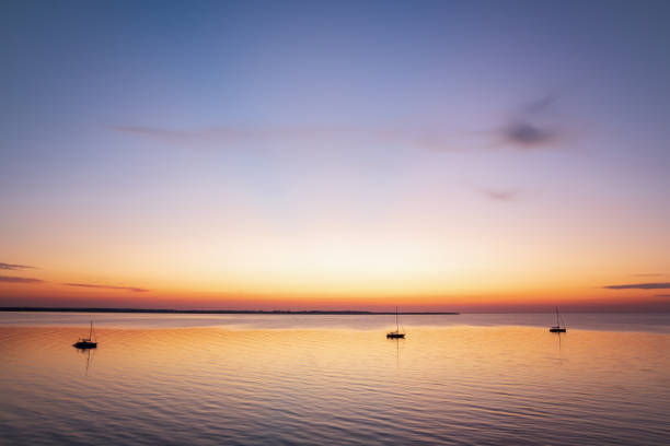 istock Three boats lying at anchor in twilight 1290532372