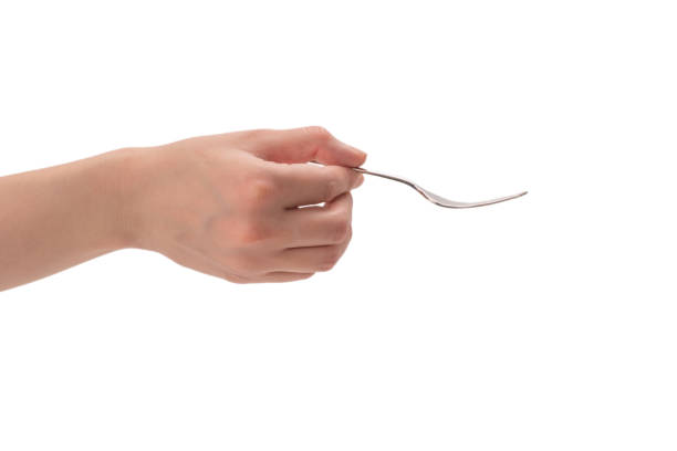 istock Fork in woman hand isolated on white. 1290533438