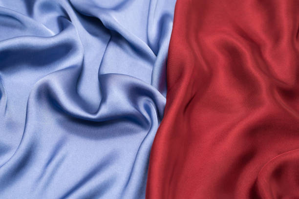 istock Red and blue silk or satin luxury fabric texture. Top view. 1290533457