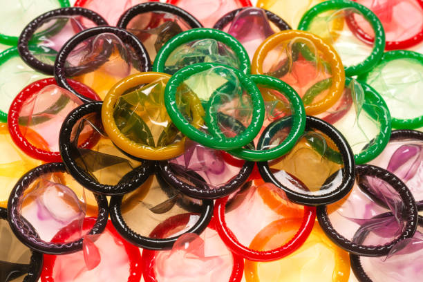 istock Colorful condoms background. 1290533460