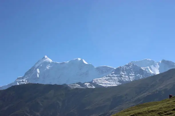 Photo of Snow covered Peak of mountain trishul in himalaya.