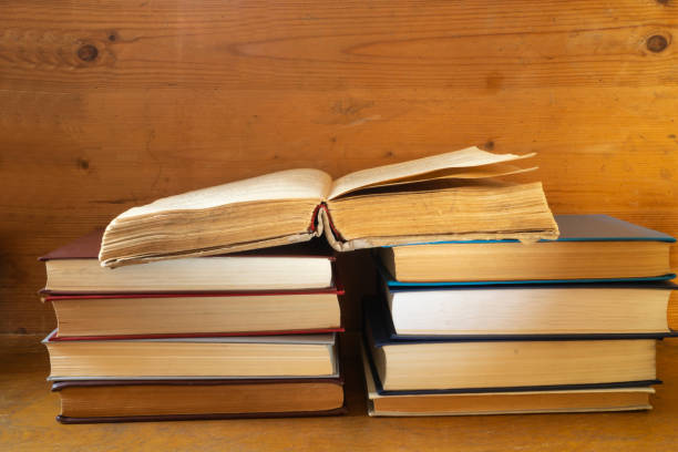istock Stack of the books rests upon wooden regimen 1290538724