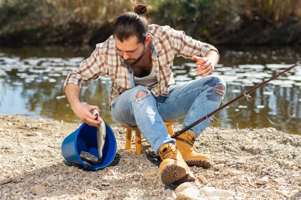 istock Lucky fisherman caught a trout fish 1290538943