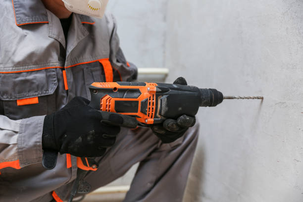 istock person hands hold hammer drill 1290540495