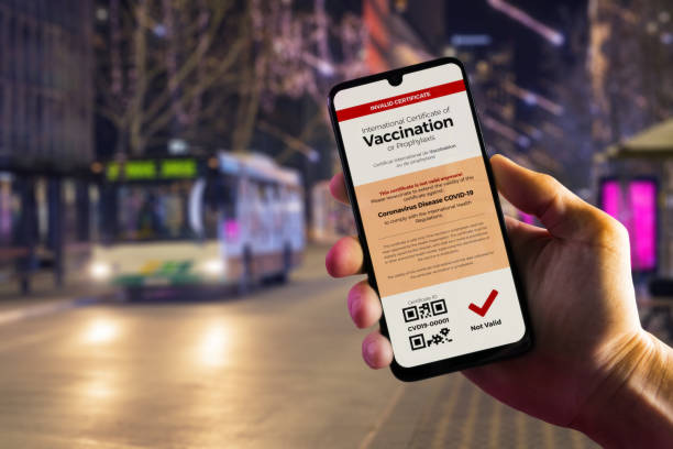 istock Smartphone displaying an invalid COVID-19 vaccination certificate in male's hand 1290542060