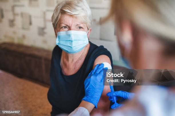 Patient Getting Vaccination At Home Stock Photo - Download Image Now - Vaccination, Senior Adult, COVID-19 Vaccine