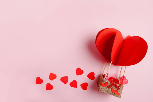 istock Valentines Day background with red parachute and small hearts on white background, copy space. 1290544953