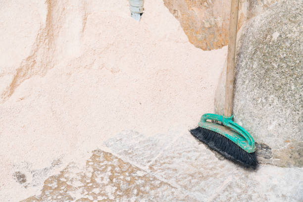 istock Old green broom for cleaning garden, sand on pavement 1290545233
