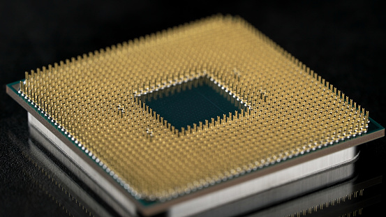 Powerful central processing unit presented in macro. Contact feet are gold plated for less resistance. The CPU is the heart of computers and servers. Electronics