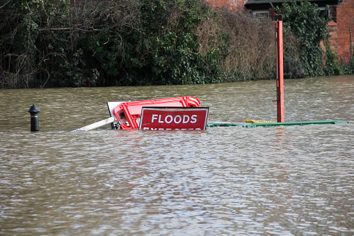 Road closed Flood signs underwater as floods have risen over them in Shrewsbury Shropshire during floods in February 2020