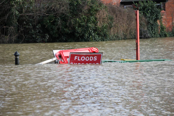Road closed Flood signs underwater as floods have risen over them in Shrewsbury Shropshire during floods in February 2020 stock photo