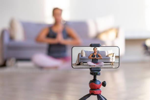istock Live streaming on a smartphone - online yoga lesson 1290546504