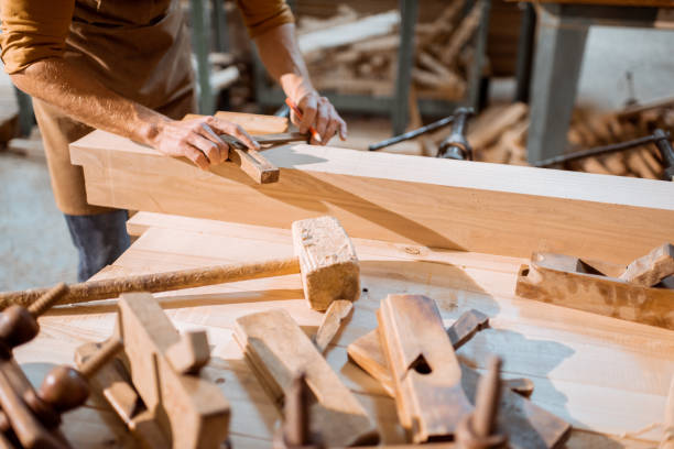 istock Carpenter working with a wood indoors 1290546604