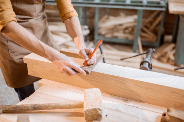 istock Carpenter working with a wood indoors 1290546618