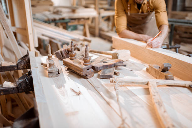 istock Carpenter working with a wood indoors 1290546661