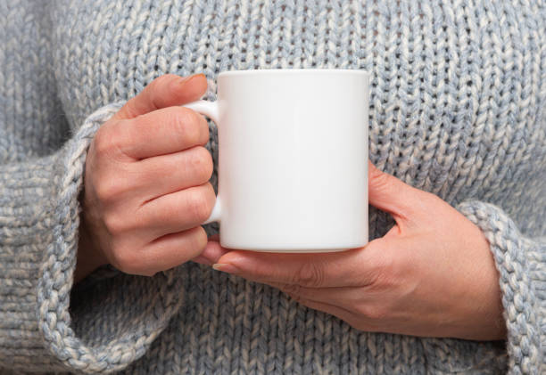 istock Girl is holding white cup in hands. 1290546704