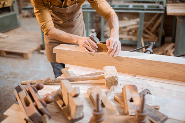istock Carpenter working with a wood in the workshop 1290546907