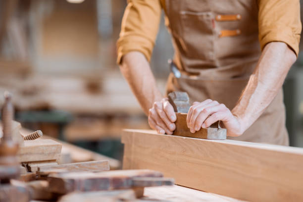 istock Carpenter working with a wood in the workshop 1290546915